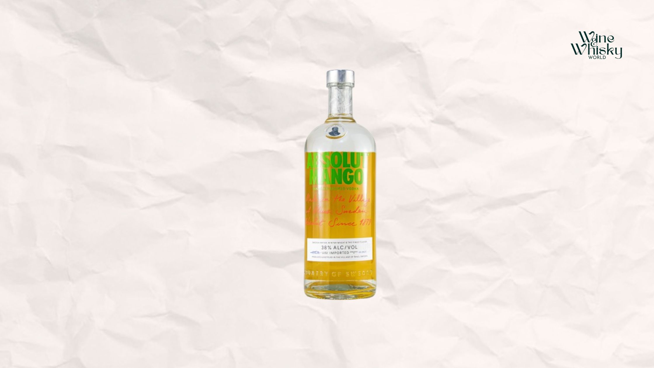 Clear glass bottle of Absolut Vodka with yellow and black text on the label, reading 'Absolut Vodka', displayed against a crumpled white paper background with the Wine Whisky World logo in the top right corner.